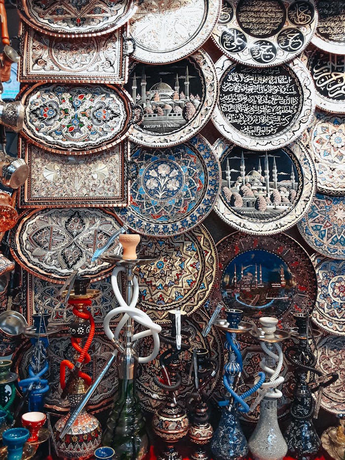 Intricately decorated plates and vibrant hookahs on display at a market stall.